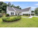 Attractive one-story home with neat landscaping, green lawn, and charming walkway to front door at 1445 Ashley Gardens Blvd, Charleston, SC 29414