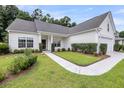 Inviting one-story home with tidy landscaping, a walkway to the front door, and a well-maintained lawn at 1445 Ashley Gardens Blvd, Charleston, SC 29414