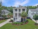 Charming two-story home with double front porches, landscaped yard, and palm trees at 1489 Red Tide Rd, Mount Pleasant, SC 29466