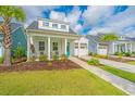Attractive home with a well-kept lawn, appealing curb appeal, and a vibrant blue front door at 1515 Pogonia St # 2, Mount Pleasant, SC 29466