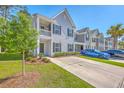 Inviting townhome with a neat front yard and a driveway for convenient parking at 163 Spencer Cir, Summerville, SC 29485