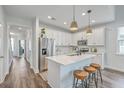 Modern kitchen features white cabinetry, stainless steel appliances, and center island with seating at 184 Kirkland St, Goose Creek, SC 29445