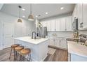 Modern kitchen features white cabinetry, stainless steel appliances, and center island with seating at 184 Kirkland St, Goose Creek, SC 29445