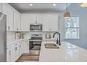 Well-lit kitchen features stainless steel appliances, white cabinetry, and marble countertops at 184 Kirkland St, Goose Creek, SC 29445
