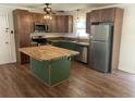 A bright kitchen featuring an island with butcher block countertop and stainless appliances at 2 Clarksville Ln, Goose Creek, SC 29445