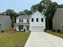 Charming two-story home with white siding, an attached two-car garage, and a freshly poured concrete driveway at 2018 Quiet Ibis Rd, Hanahan, SC 29410