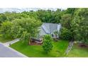 A beautiful aerial view of a home surrounded by lush greenery and mature trees at 2031 Thornhill Dr, Summerville, SC 29485