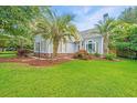A well-maintained home with palm trees and lush lawn at 2031 Thornhill Dr, Summerville, SC 29485