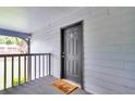 Apartment entryway with a gray door, welcome mat, and view of lush greenery at 21 Rivers Point Row # 17G, Charleston, SC 29412