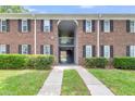 Close-up of brick apartment building showing a pathway and central staircase at 21 Rivers Point Row # 17G, Charleston, SC 29412