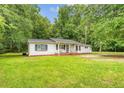 Quaint one-story house with inviting porch swing and neatly trimmed lawn at 2202 Sc-61, Ridgeville, SC 29472