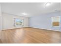 Spacious living room features light wood floors, neutral paint, large windows, and modern recessed lighting at 226 Clydesdale Cir, Summerville, SC 29486
