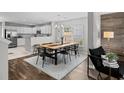 Well-lit dining area offering an open floor plan next to the modern kitchen and stylish decor at 251 Emerald Isle Dr, Moncks Corner, SC 29461