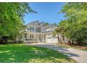 Charming two-story home with a large front yard, two-car garage and inviting front porch at 2701 Fountainhead Way, Mount Pleasant, SC 29466