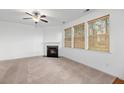 Inviting living room with a cozy fireplace, ceiling fan, and plenty of natural light at 272 Overcup Loop, Summerville, SC 29486
