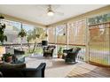 Relaxing screened porch offers comfortable seating, ceiling fan, and views of the outdoors at 3000 Treadwell St, Mount Pleasant, SC 29466