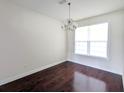 Classic dining room with hardwood floors, a stylish chandelier, and a bright window at 3254 Hartwell St, Johns Island, SC 29455