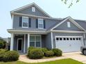 Charming two-story home with gray siding, a two-car garage, and well-maintained landscaping at 3254 Hartwell St, Johns Island, SC 29455