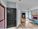 Inviting living room featuring a brick fireplace, hardwood floors, and stylish furniture at 3290 Middleburry Ln, Charleston, SC 29414