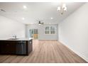 Open-concept living area with light wood floors, ceiling fan, and sliding glass doors to the outside at 335 Bremerton Dr, Goose Creek, SC 29445