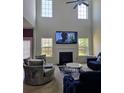 Sunlit living area features a fireplace, high ceilings, and large windows, creating a spacious and inviting atmosphere at 3706 Blackjack Rd, Ladson, SC 29456