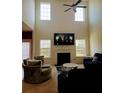 Two-story living room boasts abundant natural light, a fireplace, and stylish furnishings for a comfortable gathering space at 3706 Blackjack Rd, Ladson, SC 29456