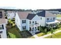Beautiful two-story home with double porches, landscaped yard, and community view at 403 Cool Bend Ln, Summerville, SC 29486