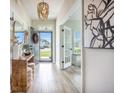 Bright hallway with an open doorway, stylish decor, views of the neighborhood, and a decorative chandelier at 603 Cavour Ct, Summerville, SC 29486