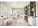 Well-lit home office featuring custom shelving, built in desk, and large windows with natural light at 603 Cavour Ct, Summerville, SC 29486