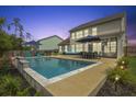 Backyard pool with patio seating under umbrellas, perfect for outdoor entertaining at 626 Chigwell Springs Ln, Summerville, SC 29486