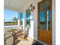 Inviting front porch with comfortable seating and a view of the surrounding landscape at 735 Maynard Ln, Summerville, SC 29486