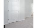Bedroom featuring neutral carpet and walls, with a white door providing access to other areas at 754 Meadowbrook Ln, Summerville, SC 29486