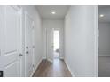 Bright hallway with wood floors, white doors, and an open view to the outdoors at 754 Meadowbrook Ln, Summerville, SC 29486
