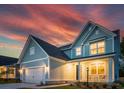 Charming two-story home with a two-car garage and a welcoming porch under a beautiful sunset at 770 Opal Wing St, Moncks Corner, SC 29461
