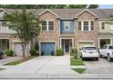 Attractive townhome featuring a stone facade, blue accents, and well-maintained landscaping at 826 Bibury Ct, Charleston, SC 29414