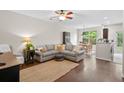 Comfortable living area with a sectional sofa, wood floors, and ample natural light at 826 Bibury Ct, Charleston, SC 29414