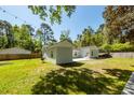 Spacious backyard with a cozy patio, ideal for outdoor gatherings and relaxation at 8562 N Highway 17, McClellanville, SC 29458