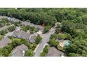 Aerial view of a charming residential neighborhood nestled among mature trees and lush landscaping at 8743 Grassy Oak Trl, North Charleston, SC 29420