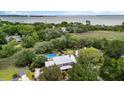Stunning aerial view showcasing the property's pool, surrounding trees, and waterfront location at 910 Kushiwah Creek Ct, Charleston, SC 29412