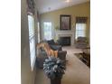Inviting living room with a fireplace, large windows, and comfortable furniture provides a relaxing space at 103 Savannah River Dr, Summerville, SC 29485
