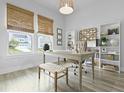 Bright home office with natural light, featuring a desk, shelving, and woven window shades at 109 Medford St, Summerville, SC 29486