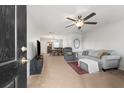 Inviting living room with modern decor, neutral tones, and open layout, featuring a ceiling fan and plush seating at 1170 Deerberry Rd, Hanahan, SC 29410
