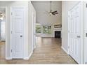 Inviting hallway view into living room featuring fireplace, wood-look flooring and an open layout at 1245 Lakefront Drive Dr, Charleston, SC 29412