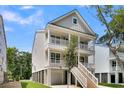 Exterior view of a two-story home featuring a staircase and a balcony at 1304 Lieben Rd, Mount Pleasant, SC 29466