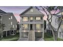 Charming two-story home with double balconies at twilight at 1304 Lieben Rd, Mount Pleasant, SC 29466