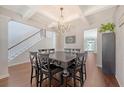 Elegant dining room featuring coffered ceilings, hardwood floors, and a stylish chandelier at 143 Airy Dr, Summerville, SC 29486