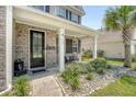 Inviting front porch with brick accents, decorative plants, and welcoming decor creates a charming entrance at 143 Airy Dr, Summerville, SC 29486