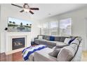 Cozy living room boasts a fireplace, large sectional, and a TV displaying a fountain view at 145 Woodbrook Way, Moncks Corner, SC 29461