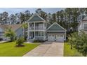 Charming home featuring a lush front lawn and a spacious two-car garage with a double driveway at 183 Calm Water Way, Summerville, SC 29486
