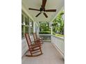 Covered porch with ceiling fan and rocking chairs at 19 Avondale Ave, Charleston, SC 29407